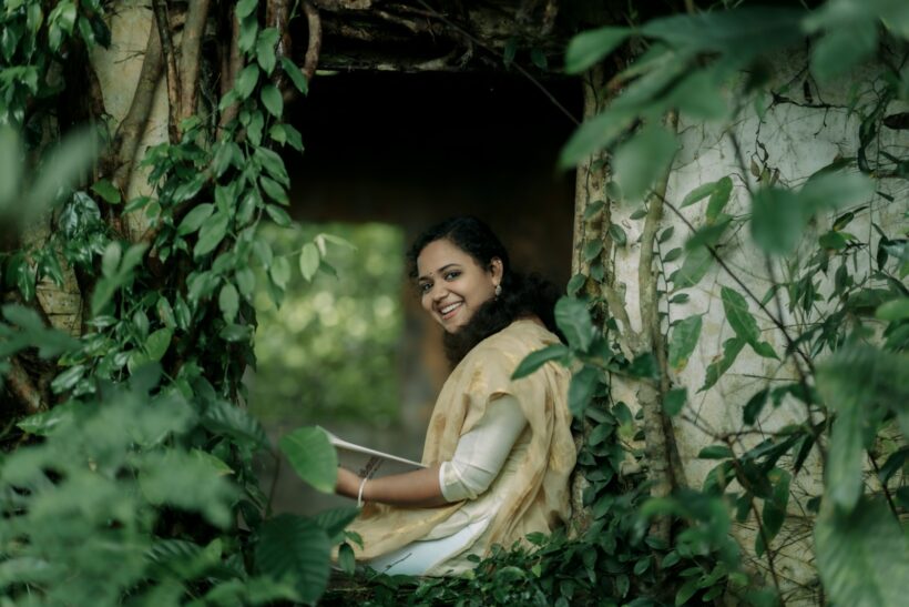 A woman sitting in a hole in the woods